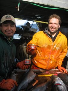 Remo Lotscher and Andy Zuanich on rocking boat with Canned Salmon