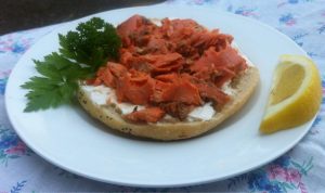 A very vibrant red sockeye salmon on a bagel