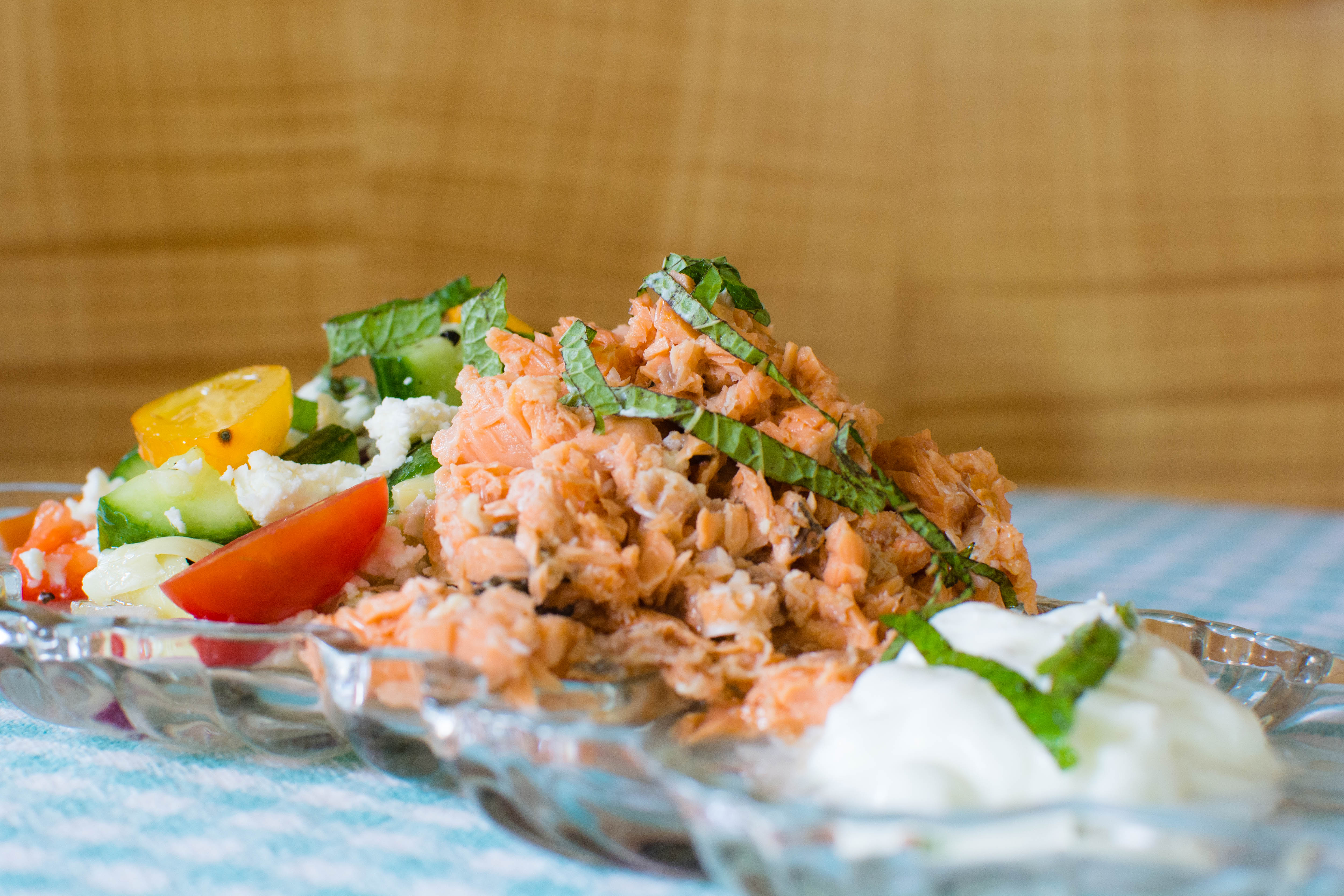 Greek Salad featuring canned salmon in a glass dish